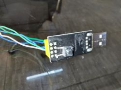 Testing device for programming ESP01, with reset button, wires, and USB connector.