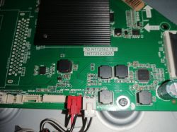Close-up of a green PCB with a black heatsink, wire connectors, and label TD.NT72563.787