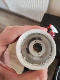 Top view of the inside of a kitchen foil roll held by a hand.