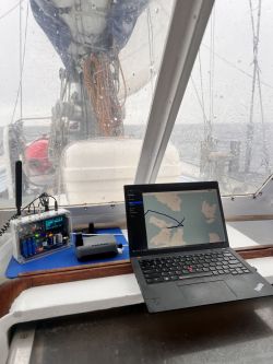 GPS Navigation on an Arctic Yacht Laptop and GPS tracker on a yacht on a rainy day.