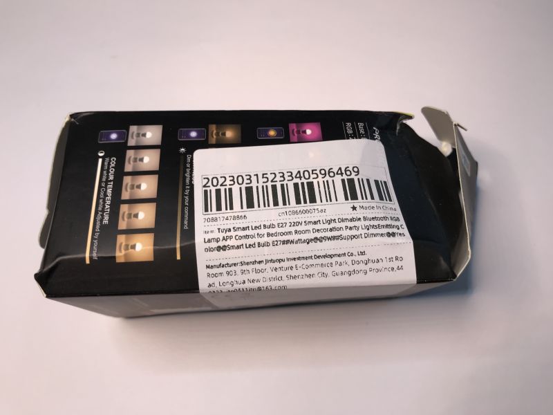 Tuya Smart LED Bulb Packaging with Barcode Damaged packaging of a LED bulb with a label and barcode.