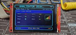 TFT display showing “ANALIZATOR ZEWN.” menu on a red PCB, with cables and ribbon in the background.