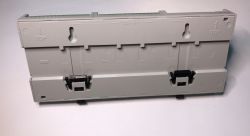 Gray plastic enclosure for mounting electronic devices on a DIN rail, viewed from the back.