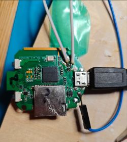 A printed circuit board with connected wires, a micro USB port, and an SD card slot.