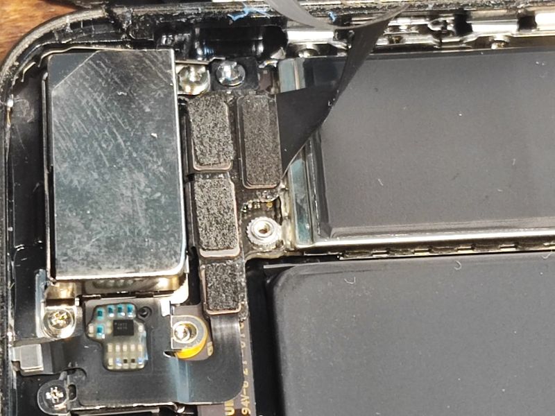 Inside of an iPhone with Visible Components Close-up view of the inside of an iPhone showing components and ribbons.