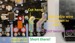 Close-up of a circuit board with markings for modification.
