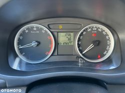 Close-up of a car dashboard with a speedometer, tachometer, and information display.