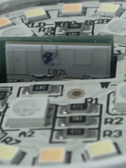 Close-up of an electronic board with a module labeled CB2L and LEDs.