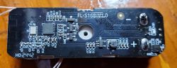 Circuit board with electronic components on a wooden surface.