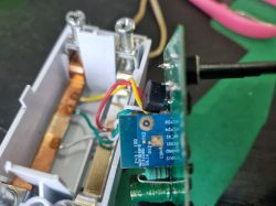 Electronic module with connected wires and visible PCB marked CB2S mounted in a smart device enclosure.