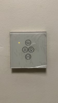 Control panel with four buttons: up, pause, light, down.