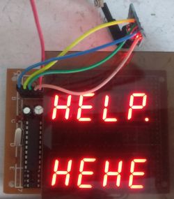 Electronic board with LED display showing “HELP.” and “HEHE”