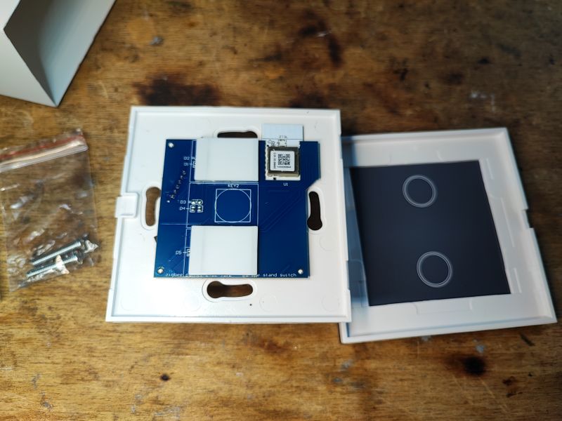 Smart Zigbee Switch Set with PCB Set with parts for a smart Zigbee light switch featuring a PCB and screws.