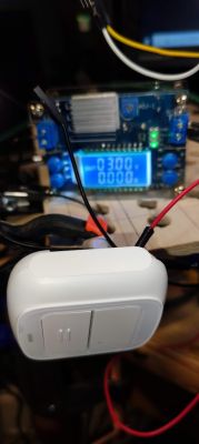Battery-powered wireless switch connected to an electronic circuit on a workbench.