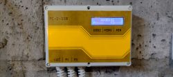 Two-channel timer with an LCD display mounted on a wall.