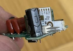 Close-up of a circuit board with a chip and labeled RX1, RX2, TX1, TX2, CEN, CSN pins.