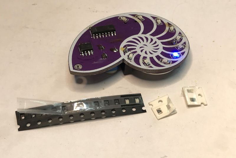 SMD Soldering Kit - Shell-Shaped PCB Shell-shaped PCB with LEDs and integrated circuits.