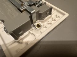 Close-up of electric socket interior showing metal mounting clip and plastic housing
