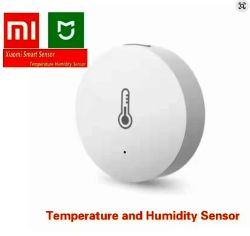 Biały czujnik Xiaomi z ikoną termometru, oznaczony jako czujnik temperatury i wilgotności