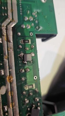 Circuit board with visible components like resistors and a rectifier bridge.
