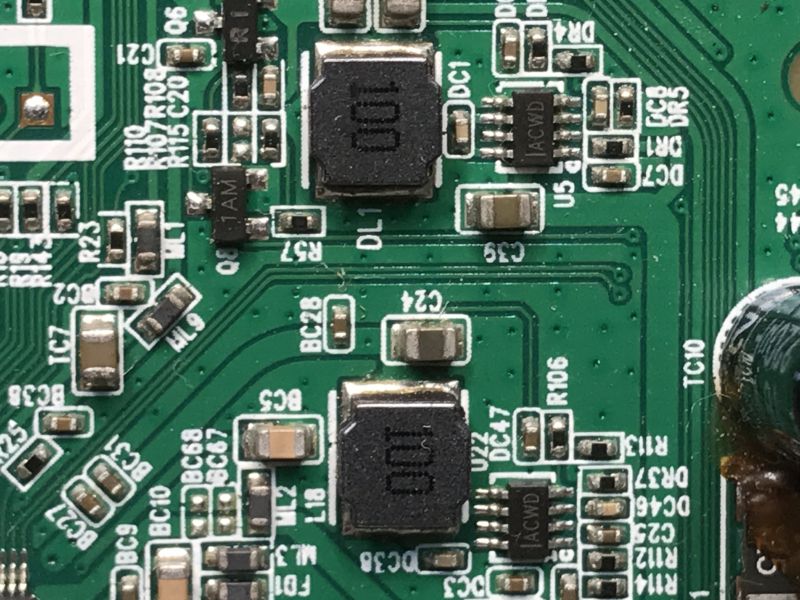 Close-up of SMD components and power inductor on a green PCB from TE 1050 HD tuner