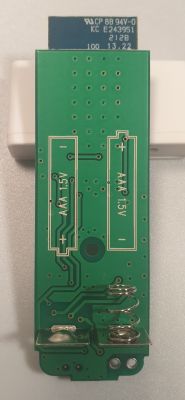 View of door sensor board with slots for AAA batteries.