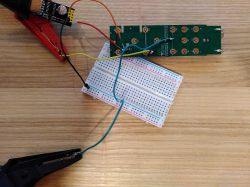 Setup of an electronic circuit on a breadboard with connected wires.