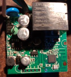 BK7231T Version PCB of Feit Plug Printed circuit board with electronic components, including capacitors, a relay, and a row of holes.