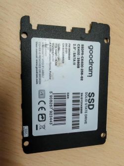 Goodram CX400 256GB SSD lying on a desk with technical label facing up