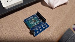 Electronic Module with Wi-Fi Antenna and Microcontroller Electronic module on a blue PCB with a Wi-Fi antenna and microcontroller.