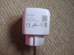 Smart Plug with Technical Information Smart plug with technical information on a carpet background.
