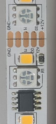 Close-up of LED Strip with Integrated Circuit Close-up of an LED strip with visible components, including diodes and an integrated circuit.