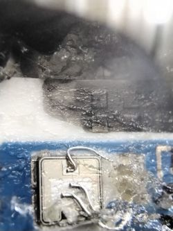 Close-up of a circuit board with visible burn marks.