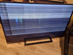 Toshiba TV screen with a distorted image full of horizontal lines.