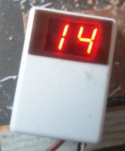 Thermometer with red LED display showing a temperature of 14 degrees