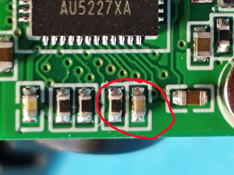 Close-up of a PCB with two SMD components circled in red