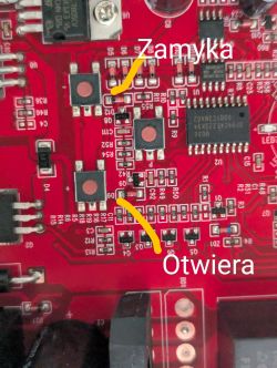 Close-up of a circuit board with marked buttons for opening and closing.