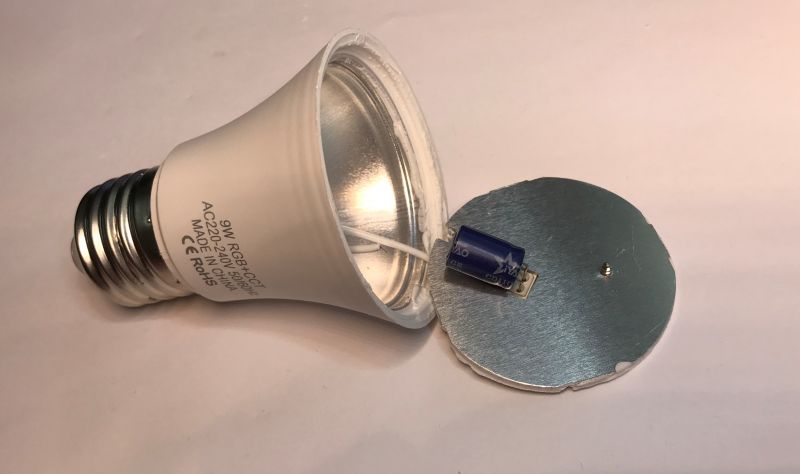 Dismantled RGB/CCT LED Bulb with Internal Components Dismantled RGB/CCT LED bulb with visible circuit board and capacitor.