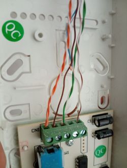 Close-up view of an intercom circuit board with connected wires.