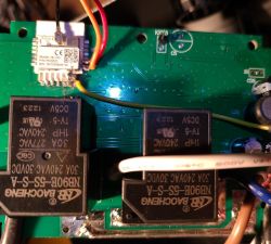 Close-up of a motherboard with soldered wires and visible components.