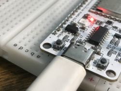 Close-up of Development Board with USB and LED Close-up of a development board with a connected USB cable and lit LED.