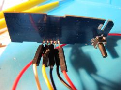 Modified PCB with Soldered Wires PCB board with soldered wires and a button.