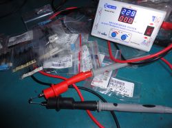 Electronic tester on a table with diodes and measurement cables.