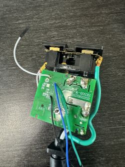 Open Circuit Board of Microcenter Smart Outdoor Plug Open circuit board with wires and electronic components.