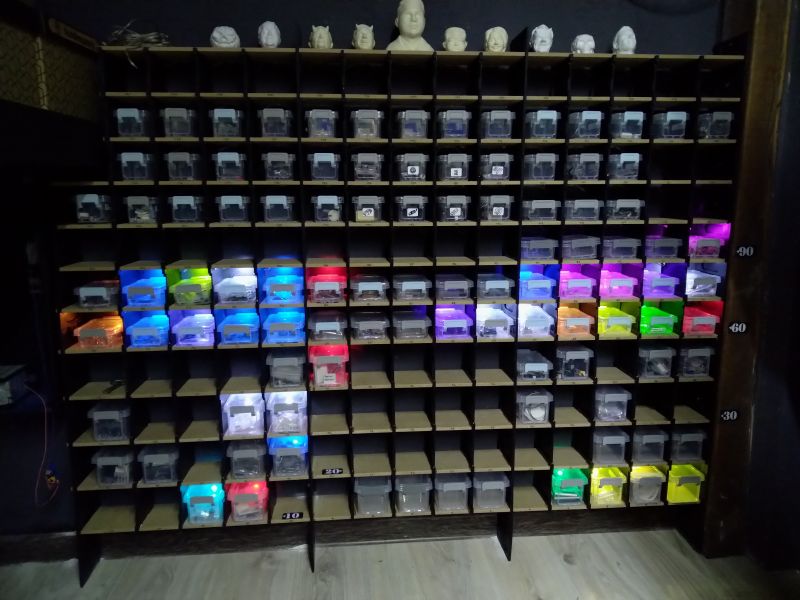 Shelf with transparent boxes illuminated by multicolored LED lights