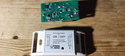 ESP8285 Wi-Fi smart switch module and PCB shown on a wooden table