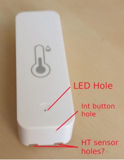 White Temperature and Humidity Sensor from AliExpress White rectangular sensor with labeled holes for LED, int button, and possible HT sensor.