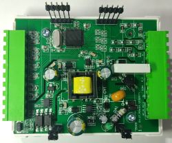 Printed circuit board with electronic components and green terminal blocks