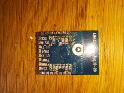 LMA35 electronic module with visible pins on a wooden surface.