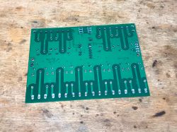 Printed circuit board on wooden surface.